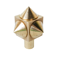 Close-up of a raw brass spike cube knob with a bold, geometric design, featuring four rounded brass spikes on a solid brass cube base.