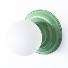 Stepping back into a bygone era with a touch of modern minimalism, the Abeille Sconce or Flushmount in a muted vista  green is an artistic blend of form and function. This wall sconce doubles as a flushmount ceiling light, making it a versatile lighting solution for any space. Designed akin to a beehive, its charismatic shape is complemented by curated color options that add a playful element to its retro appeal.