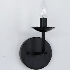 All Black Scalloped feminine wall sconce light fixture.  The bobeche has a scalloped border with a similar bent arm.  Candelabra bulb.
