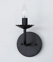 All Black Scalloped feminine wall sconce light fixture.  The bobeche has a scalloped border with a similar bent arm.  Candelabra bulb.
