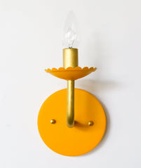Mustard and Brass feminine wall sconce with scalloped bobeche detail