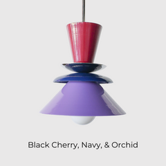Astro pendant light featuring a bold colorblocked design in Black Cherry, Navy, and Orchid. This sculptural ceiling light is handcrafted with powder-coated metal in a tiered, mid-century modern inspired silhouette. A striking and vibrant choice for kitchens, dining spaces, or eclectic interiors, it brings playful sophistication and a pop of color to maximalist and design-forward homes. Ideal as a single statement piece or grouped over an island.