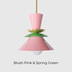 Astro pendant light in blush pink and spring green with a colorblocked design and brass accent. Mid century modern-inspired hanging light perfect for playful, eclectic, or colorful kitchens and dining rooms. A bold statement fixture for maximalist interiors or pastel color lovers looking for unique handcrafted lighting.
