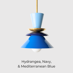 Colorblocked Astro pendant light in hydrangea blue, navy, and Mediterranean blue with a warm brass accent. This sculptural, mid century modern-inspired ceiling fixture adds a bold pop of color to any space. Perfect for eclectic kitchens, creative dining areas, playful living rooms, or vibrant entryways. A statement pendant designed for maximalist interiors, retro-modern homes, or anyone looking to infuse personality and color into their lighting.