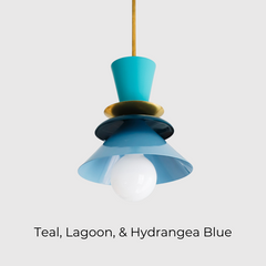 Colorblocked Astro pendant light in vibrant teal, lagoon blue, and hydrangea with a brass accent. This bold mid century modern-inspired ceiling light is perfect for eclectic kitchens, playful dining spaces, or statement entryways. Ideal for color lovers and maximalist interiors, this sculptural fixture adds personality and modern charm in a compact pendant form.