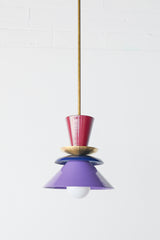 Astro pendant light featuring a bold colorblocked design in Black Cherry, Navy, and Orchid. This sculptural ceiling light is handcrafted with powder-coated metal in a tiered, mid-century modern inspired silhouette. A striking and vibrant choice for kitchens, dining spaces, or eclectic interiors, it brings playful sophistication and a pop of color to maximalist and design-forward homes. Ideal as a single statement piece or grouped over an island.