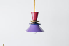 Astro pendant light featuring a bold colorblocked design in Black Cherry, Navy, and Orchid. This sculptural ceiling light is handcrafted with powder-coated metal in a tiered, mid-century modern inspired silhouette. A striking and vibrant choice for kitchens, dining spaces, or eclectic interiors, it brings playful sophistication and a pop of color to maximalist and design-forward homes. Ideal as a single statement piece or grouped over an island.