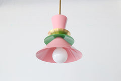 Astro pendant light in blush pink and spring green with a colorblocked design and brass accent. Mid century modern-inspired hanging light perfect for playful, eclectic, or colorful kitchens and dining rooms. A bold statement fixture for maximalist interiors or pastel color lovers looking for unique handcrafted lighting.