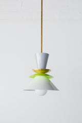 Astro pendant light in a crisp colorblocked palette of grey, chartreuse, and white. This modern ceiling fixture is inspired by mid-century design, featuring stacked powder-coated metal shapes in a sculptural silhouette. The vibrant pop of chartreuse adds playful contrast to the soft neutrals, making it an ideal lighting choice for eclectic, retro, or minimalist kitchens and dining spaces. Designed to stand out, whether used as a single pendant or in a bold row above a kitchen island.