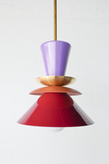Astro Pendant light fixture designed with layered, powdercoated aluminum shades in orchid purple, matte terra cotta, and deep black cherry. Features a central brass accent and is suspended from a brass rod. Handmade in New Orleans by Sazerac Stitches, this bold ceiling light combines sculptural form with customizable color. Midcentury modern style pendant light perfect for maximalist or eclectic interiors.