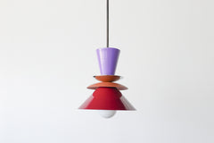 Astro Pendant light fixture designed with layered, powdercoated aluminum shades in orchid purple, matte terra cotta, and deep black cherry. Features a central brass accent and is suspended from a brass rod. Handmade in New Orleans by Sazerac Stitches, this bold ceiling light combines sculptural form with customizable color. Midcentury modern style pendant light perfect for maximalist or eclectic interiors.
