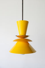 Astro pendant light featuring a bold colorblocked design in bright yellow and matte mustard. A modern statement fixture inspired by mid century modern lighting, perfect for kitchens, dining areas, or eclectic interiors. This handcrafted pendant adds a pop of retro charm and vibrant color, ideal for maximalist home decor or colorful kitchen design.