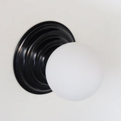 Modern black and white wall sconce or flushmount ceiling light fixture. Features a slightly beehive shaped wall plate that blends seamlessly with art deco, traditional, geometric design, and more.