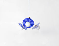 Mid-century modern pendant light fixture with colorful, etched acrylic discs.