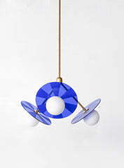 Mid-century modern pendant light fixture with colorful, etched acrylic discs.