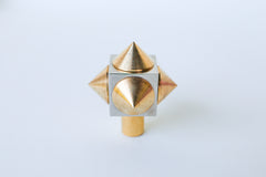 Angled shot of a spike cube knob with a chrome base and brass spikes, highlighting its sharp yet refined aesthetic and high-quality construction.