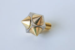 Angled shot of a spike cube knob with a chrome base and brass spikes, highlighting its sharp yet refined aesthetic and high-quality construction.