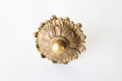 The Soleil knob features a cast brass sun-shape with a modern cap.  Adds a touch of regency to any home decor. The cast brass component of the knob is made in italy.  Adds texture to any antique or modern piece of furniture and cabinetry. Beautiful, rich raw brass finish. The raw brass finish will develop a patina with time.