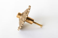 The Soleil knob features a cast brass sun-shape with a modern cap.  Adds a touch of regency to any home decor. The cast brass component of the knob is made in italy.  Adds texture to any antique or modern piece of furniture and cabinetry. Beautiful, rich raw brass finish. The raw brass finish will develop a patina with time.
