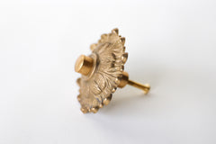 The Soleil knob features a cast brass sun-shape with a modern cap.  Adds a touch of regency to any home decor. The cast brass component of the knob is made in italy.  Adds texture to any antique or modern piece of furniture and cabinetry. Beautiful, rich raw brass finish. The raw brass finish will develop a patina with time.