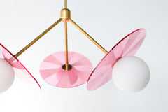 Mid-century modern pendant light fixture with colorful, etched acrylic discs.