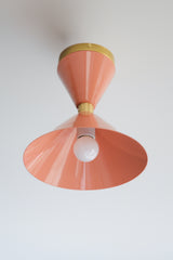 Peach and Brass flushmount ceiling light fixture in a midcentury modern double cone shape