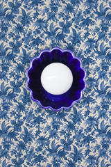 Handmade ceramic cobalt blue Marcella flushmount ceiling light with brass fixture by Sazerac Stitches, mounted on a Delft blue floral wallpapered ceiling for a bold and elegant home lighting statement.