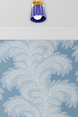 Handmade cobalt blue ceramic Marcella flushmount ceiling light with brass hardware by Sazerac Stitches, installed on a white ceiling with crown molding and soft blue and white botanical wallpaper, ideal for kitchens, bathrooms, or hallways.