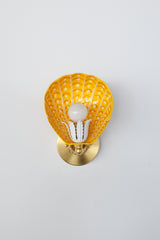 Handcrafted wall-mounted shell sconce with warm yellow, tangerine orange, and white painted steel shade – unique maximalist light fixture with brass mounting plate