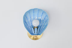 Handcrafted powdercoated steel shell sconce in celestial blue and ivory, maximalist wall lighting with brass mount, ocean-inspired palette, made-to-order in New Orleans