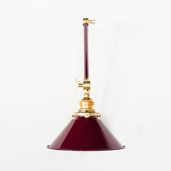 Black Cherry and brass adjustable wall sconce that adds colors and directed lighting anywhere it is needed.
