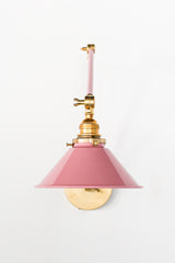 Pastel Pink & Brass adjustable wall sconce with a cone shade, brass swivels, powdercoated arms, and more.