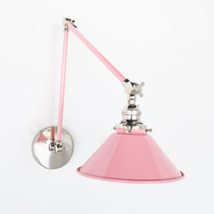 Pastel Light pink and chrome modern wall sconce with an adjustable arm.  Modern wall sconce for bedrooms, above open shelving.