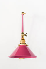Doll Pink and Brass adjustable wall sconce with a classic conical shade.  This adjustable wall sconce features a classic conical shade with a modern twist on finishes. Perfect for adding a touch of industrial chic to your space. 