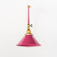 Doll Pink and Brass adjustable wall sconce with a classic conical shade.  This adjustable wall sconce features a classic conical shade with a modern twist on finishes. Perfect for adding a touch of industrial chic to your space.