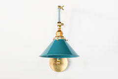 Adjustable traditional style wall sconce with a conical shade in a fun teal color.  Adds a pop of color to any space and great for colorful kid-friendly homes