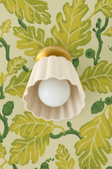 Cream Marcella Flushmount with Vibrant Green Oak Leaf Wallpaper
Alt Tag: Cream Marcella Flushmount ceiling fixture by Sazerac Stitches, with a fluted ceramic shade and warm brass mount, shown against vibrant green oak leaf patterned wallpaper to inspire bold, botanical-themed room designs.