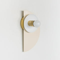 Geometric Kin Sconce in a serene cream and peach colorway with warm brass accents. This bold yet soft fixture blends Memphis-inspired form with timeless tones—ideal for mid-century modern, Scandinavian, or eclectic homes.
