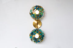 Modern two light wall sconce with brass hardware. Features resin-encapsulated greenery, ferns, and leaves.  Adds a real-like nature theme to any interior design project.  Called the Botanico Sconce by Sazerac Stitches. Features blue & white flowers with white greenery