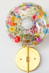 Encapsulated Floral two light wall sconce with flowers in every color flowers and greenery.  Unique wall light with real florals and greenery.  Adds a botanical and nature theme to lighting. Botanico sconce by Sazerac Stitches. multi-colored floral wall sconce light fixture.