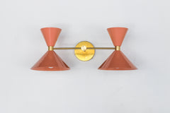 Peach and Brass mid Century modern style two light wall sconce fixture by Sazerac Stitches.  Adds a pop of "peach Fuzz" color to any decor style.  Great way to add a pop of peach to bathroom decor.