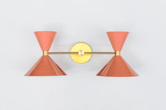 Peach and Brass mid Century modern style two light wall sconce fixture by Sazerac Stitches.  Adds a pop of "peach Fuzz" color to any decor style.  Great way to add a pop of peach to bathroom decor.