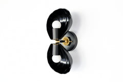 Black double shell wall sconce with brass hardware, styled for bathrooms, hallways, or sunrooms in Art Deco, Hollywood Regency, or bold contemporary homes.