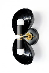 Coquille Sconce in glossy black powder-coated steel with fluted shell shades and vintage-style brass accents, ideal for eclectic, maximalist, or beach-inspired interiors.