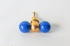 Modern brass and bright Mediterranean blue drawer pull with color-blocked steel balls, perfect for contemporary, eclectic, and maximalist home decor. Handmade in New Orleans, this bold cabinet knob adds a pop of color to kitchens, dressers, or bathroom vanities with its sculptural design and solid brass detailing.