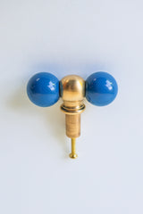 Playful and modern denim blue and brass drawer pull styled with double round knobs, ideal for eclectic, colorful interiors. This handcrafted piece is perfect for maximalist spaces, kids’ rooms, creative offices, or anyone looking to add joyful, design-forward hardware to drawers or cabinetry.