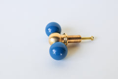 Playful and modern denim blue and brass drawer pull styled with double round knobs, ideal for eclectic, colorful interiors. This handcrafted piece is perfect for maximalist spaces, kids’ rooms, creative offices, or anyone looking to add joyful, design-forward hardware to drawers or cabinetry.