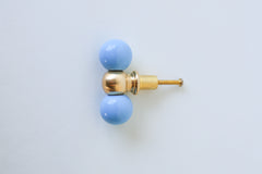 Modern brass and pastel celestial blue drawer pull with color-blocked steel balls, perfect for contemporary, eclectic, and maximalist home decor. Handmade in New Orleans, this bold cabinet knob adds a pop of color to kitchens, dressers, or bathroom vanities with its sculptural design and solid brass detailing.
