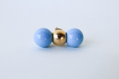 Modern brass and pastel celestial blue drawer pull with color-blocked steel balls, perfect for contemporary, eclectic, and maximalist home decor. Handmade in New Orleans, this bold cabinet knob adds a pop of color to kitchens, dressers, or bathroom vanities with its sculptural design and solid brass detailing.