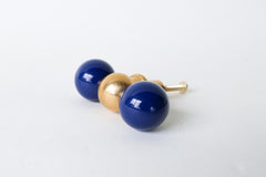 The Double Gumball drawer pull in navy blue and brass adds a bold, sculptural touch to furniture and cabinetry. This oversized modern knob is handcrafted in New Orleans and features glossy powder-coated navy blue spheres flanking a solid raw brass center. Its playful silhouette makes it perfect for eclectic and maximalist interiors, kids’ spaces, or statement-making dressers. The raw brass naturally patinas over time, offering warmth and character to any room. Ideal for non-kitchen uses like large drawers,